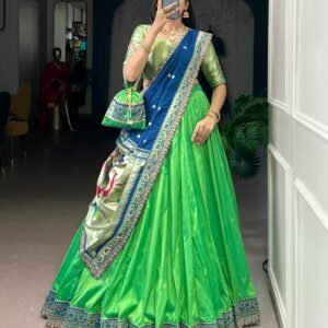 draped in refreshing shades of green, this soft silk lehenga choli shines with intricate zari weaving, delicate sequins, thread embroidery, and an elegant scallop lace border